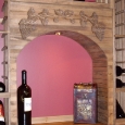 solid-arch-with-cooperage-wine-barrel-tabletop-and-big-bottle-horizontal-display-above