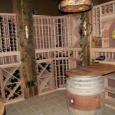 Custom wine cellar with unfinished premium redwood wine racks and wine barrel tabletops Chicago Illinois