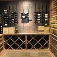 Custom Wine Cellar in Memphis Tennessee - wine room back wall with metal racks above and wood solid diamond bins below