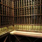 How to Build a Custom Wine Cellar - Wine Cellar Lighting LED over display row and Cooperage wine barrel tabletop