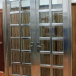 $5,995.00  304 Stainless  Double tempered glass  Design is in between glass for easy cleaning  Door is mounted to frame  Handle, lock & keys included  Mounting bolts Included  Rough Cut: 76 ½” X 99 ½””  Door Size: 72” X 95””  Door swings out  5 year warranty