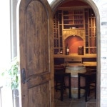 Open door into wine cellar. Racking in mahogany with Early American stain.