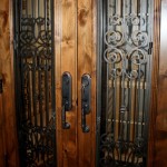 2 Black custom iron design on Knotty alder custom wine cellar doors with early american stain and lacquer