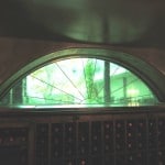 Stained Glass Double Pane Window with Sunburst Design and Green Antique Glass New Orleans Wine Cellar