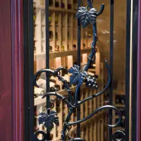 Hand forged grapevine wrought iron design on Tuscan door.
