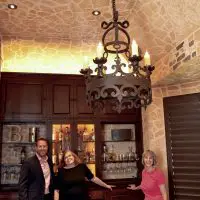 Matt Helm and Nancy Higgins standing with a friend in this Dallas Wine Cellar. A custom wine cellar and a tasting room can really make a house more of a home now while increasing your home\'s resale value in the future.