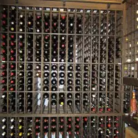 Large custom wine cellar with wooden wine racks with one bottle deep storage.
