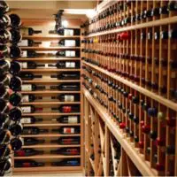 Custom wine racks were made to fit a variety of magnum sized bottles in this traditional cellar.