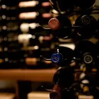 A closer look on this wooden racks filled with wines.
