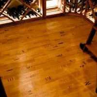 Wine barrel flooring adds another beautiful touch to this wine cellar.