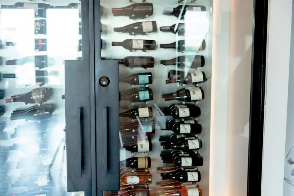 Elegant Glass Wine Closet in a High Rise Condo in Dallas Installed with Metal Pegs