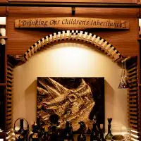 This decorative arch is the visual centerpiece of this transitional wine cellar.