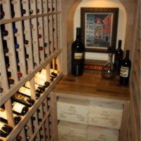 Left and back wall show racks in unfinished knotty alder Texas wine cellar