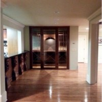 A medium distance from the outside of a custom wine cellar in an Atlanta home entertainment area.
