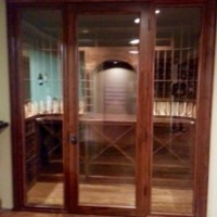 Outside shot of Custom Wine Cellar's doors made from Knotty Alder and double paned glass.