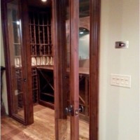 Door opens up to reveal elegant custom wine cellar in Atlanta home.