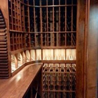 From the side we see custom wine racks stained in Chestnut with lighted display row.