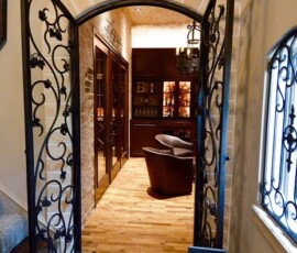 The entryway to the inside of this Dallas, Fort Worth custom wine cellar. This robust door definitely has character and elegance, and those attributes are valuable during resale. Inviting, yet robust, these doors welcome visitors into the wine cellar.