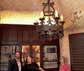 Matt Helm and Nancy Higgins standing with a friend in this Dallas Wine Cellar. A custom wine cellar and a tasting room can really make a house more of a home now while increasing your home's resale value in the future.