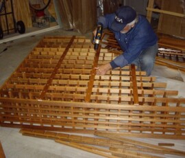 21 Wine Rack Assembly in the Garage Screwing the Back Stabilizers
