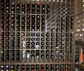 Large custom wine cellar with wooden wine racks with one bottle deep storage.