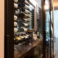 5 - Walk-in small wine cellar design with espresso-stained wooden wine racks