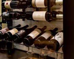 W-Series Racks makeup the modern wine rack section of this transitional wine closet.